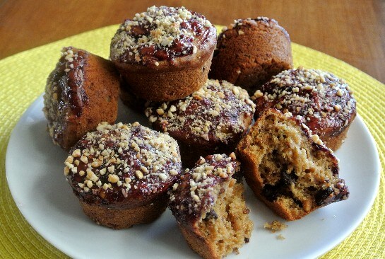 A white plate is holding ar least 10 muffins to show the topping.