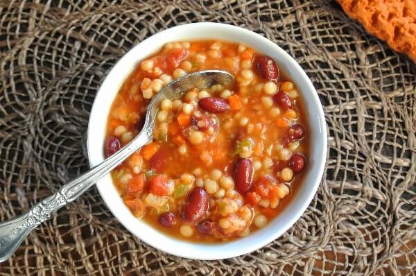 Overhead view of a few of the ingredients including beans, couscous and carrots.