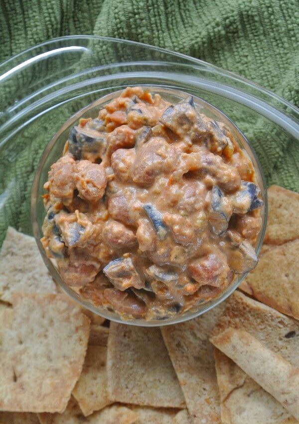 A n ocerhead photo showing creamy rich brown dip with lots of texture and pita chips on the side.