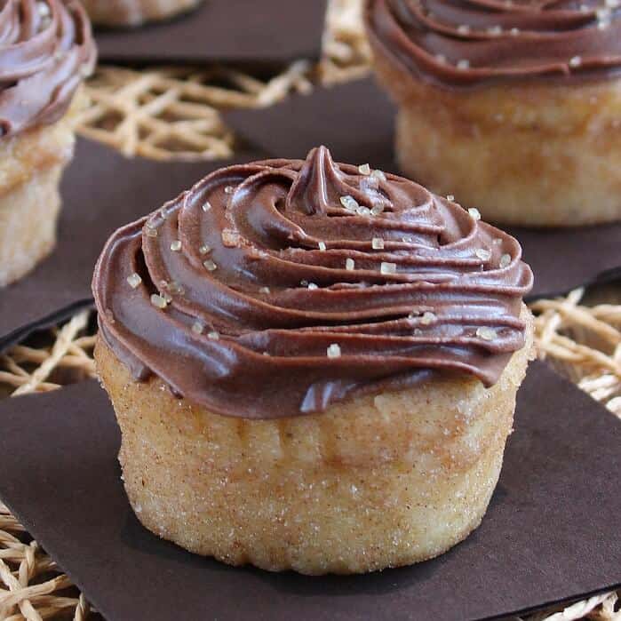 A square photo with one Lemon cupcake filling the picture with raw sugar crystals sprinkled on the frosted top.