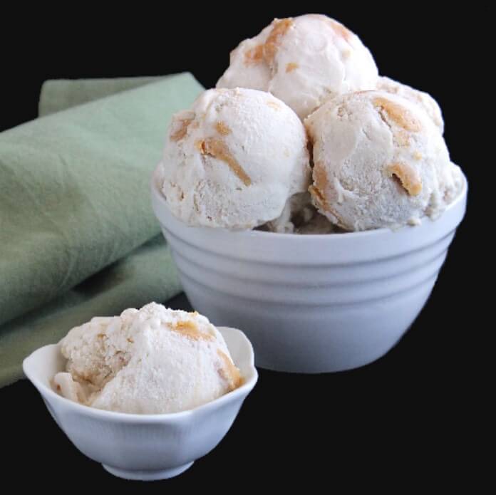 Two white bowls filled with chunky maple peanut butter ice cream
