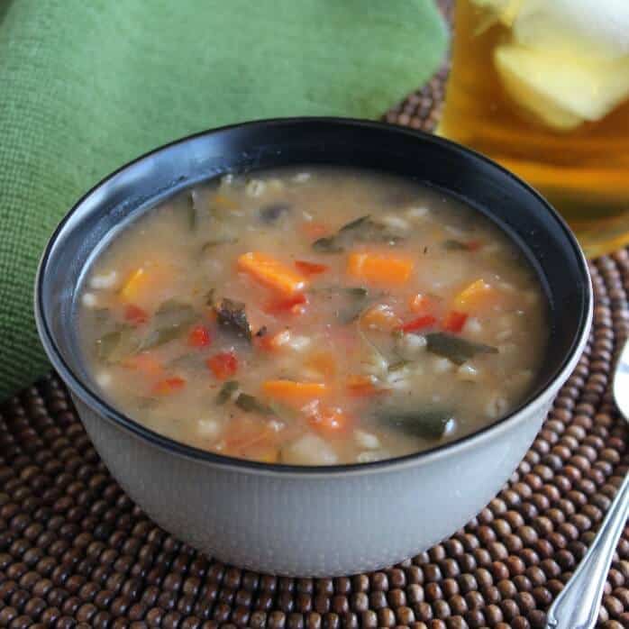 Vegetable Barley Soup with  view of the rich brothy soup showing vegetables.