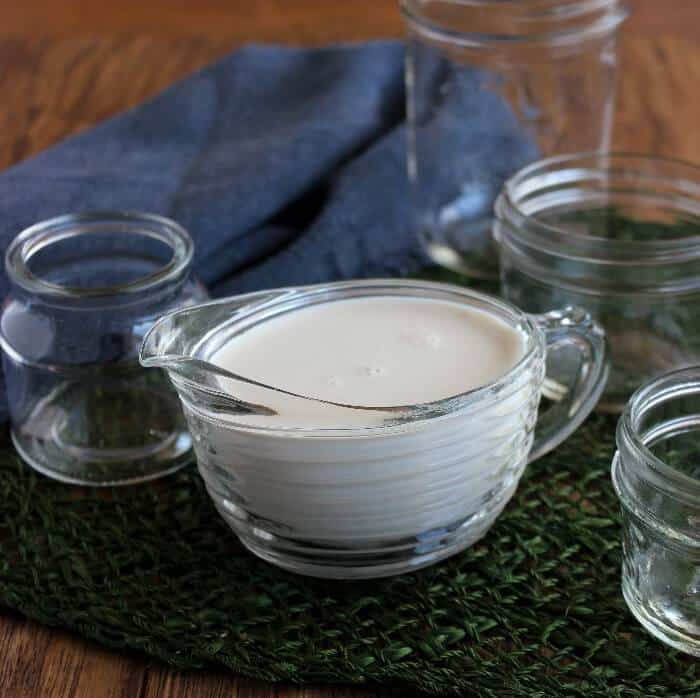 Creamy condensed milk in a ribbed creamer.