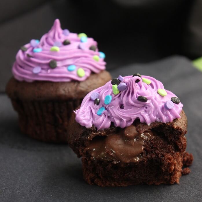 Halloween Chocolate Lava Cupcakes are dressed up for October. There is a creamy rich chocolate center that stays like that all the way to the last bite.