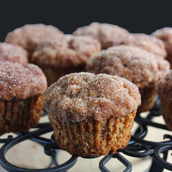 Apple Crisp Muffins are sitting on as black trivet.