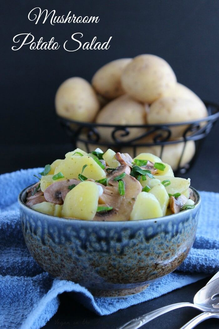 Mushroom Potato Salad in a wedgwood blue bowl sprinkled with fresh parsley.
