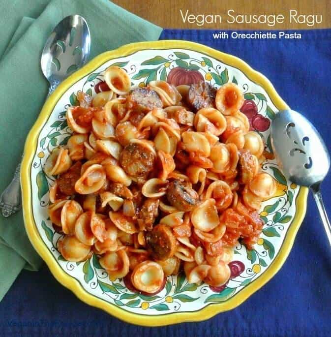 Vegan Sausage Ragu is in a Tuscan designed plate with a serving spoon on the side.