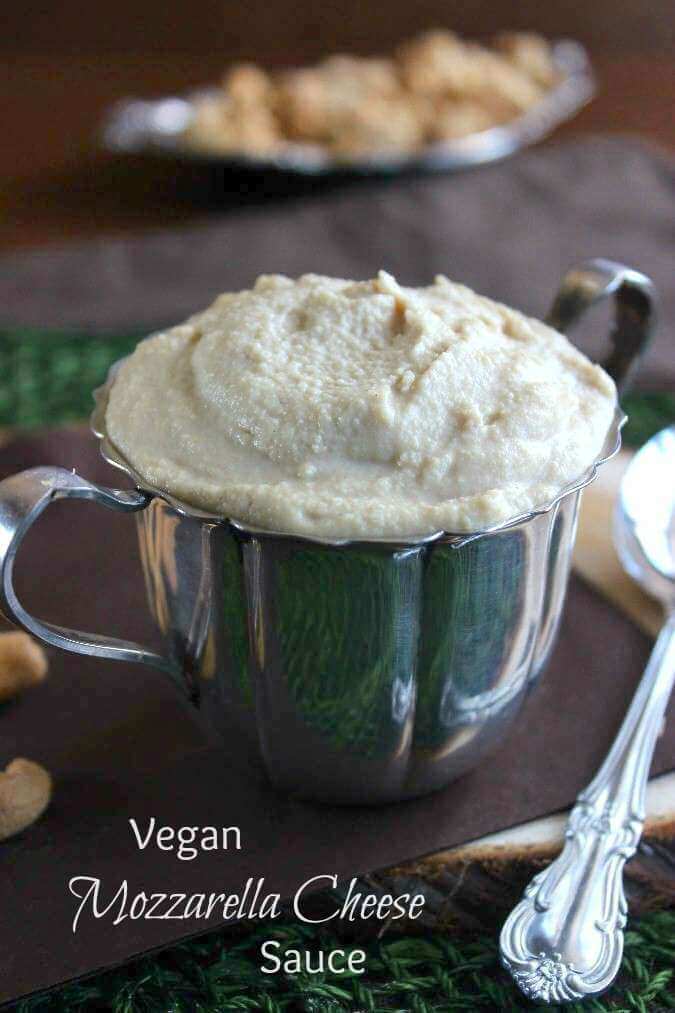 Vegan Mozzarella is swirled and piled high in a silverplate sugar cup with a spoon on the side for spreading.