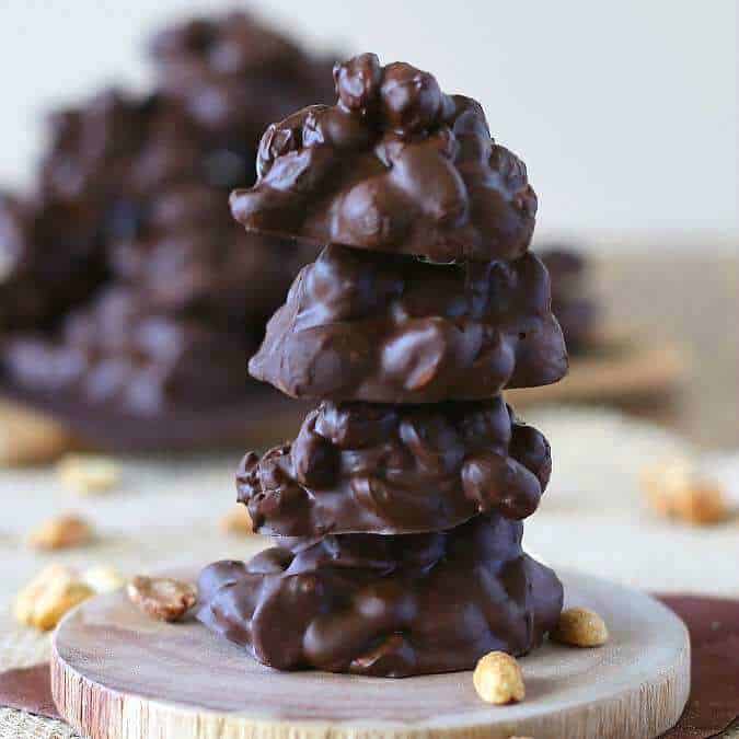 Square photos of Slow Cooker Chocolate Clusters in a stack of four candies.