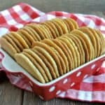 Cinnamon Sugar Cookies lined up back to back in a red and white polka dot bowl. Golden cookies sprinkled with cinnamon sugar.