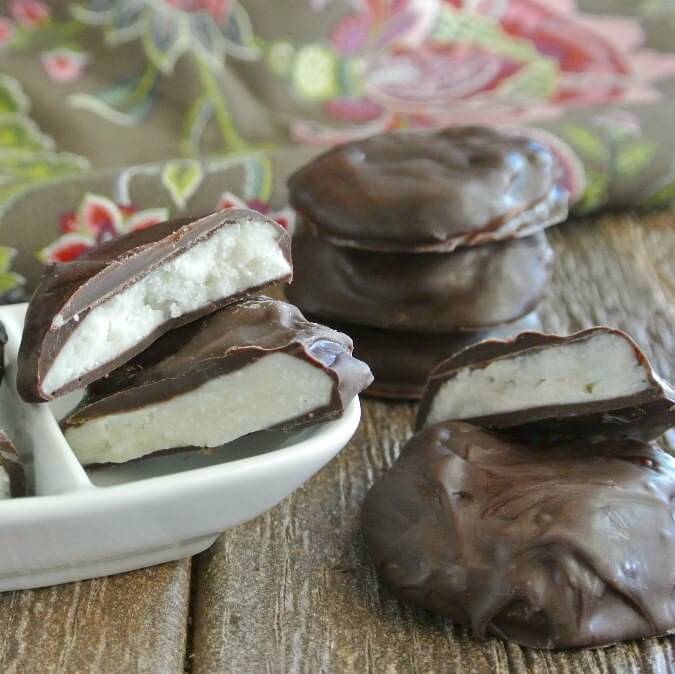 Homemade Peppermint Patties are stacked every which way and tilited out of a small white bowl.