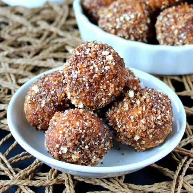 Cashew Sugared Donut Holes are an original. Little round deep fried donuts are rolled in a coconut maple flavor mixture.