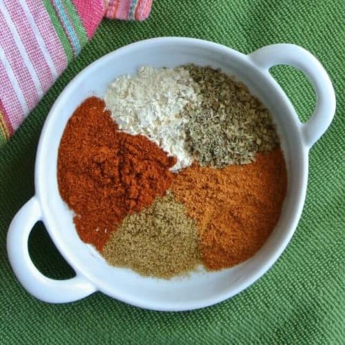 Overhead view of a white saucer with each ingredients next to each other.