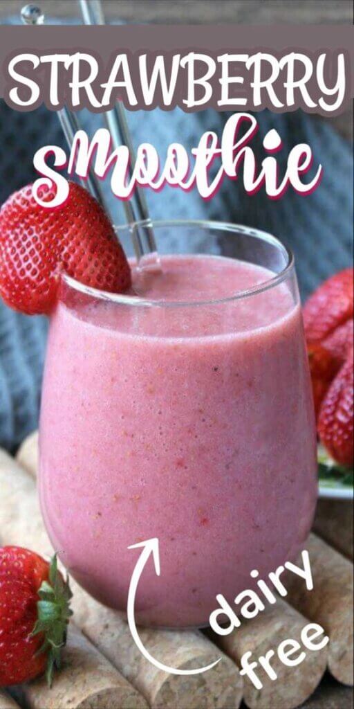 Glass filled with strawberry smoothie and fresh strawberries on the side.