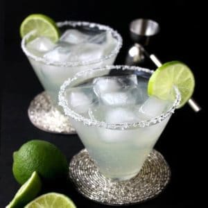 Silver Cadillac Margarita in a flared glass with lime on the edge.