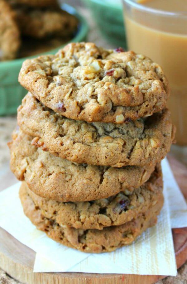 Dairy-Free Oatmeal Cranberry Cookies are stacked 5 cookie high with a very close-up photo to see all of the ingredients baked in.