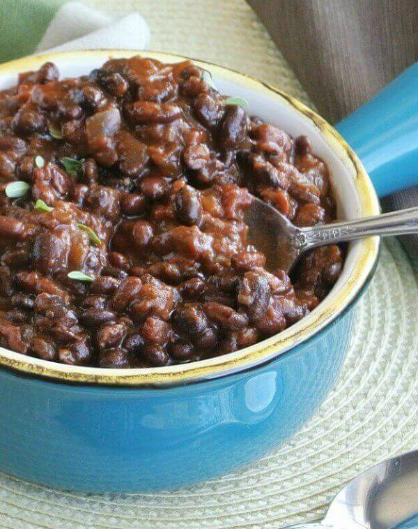 Slow Cooker Black Bean Chili is easy, delicious and an inexpensive meal served in a turquoise bowl with a spoon scooping out a bite-full.
