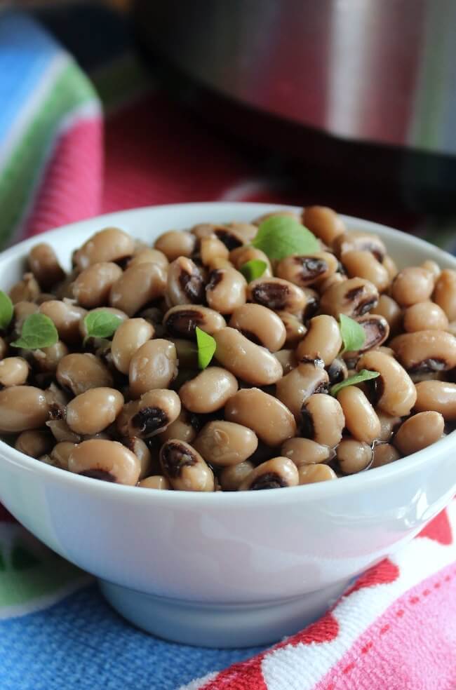 Slow Cooker Black Eyed Peas centered as a close-up and sprinkles with fresh herbs.