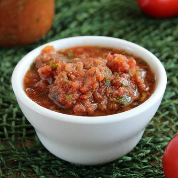 Slow Cooker Salsa is perfect & adds a lots of flavor to your chips, tacos, sandwiches, soups & more.