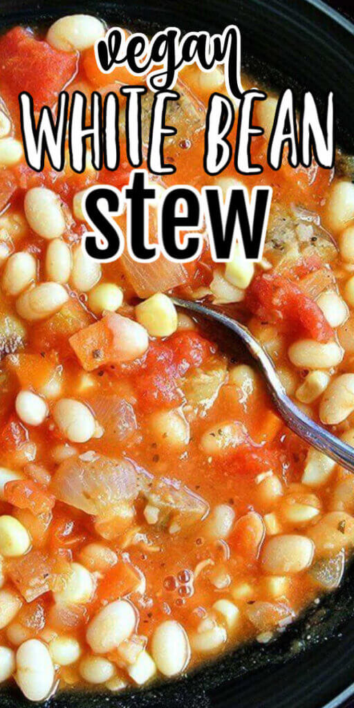 A closeup of white bean stew with tomatotoes and plant based sausage with a spoon taking up a bite. Text above for pinning.