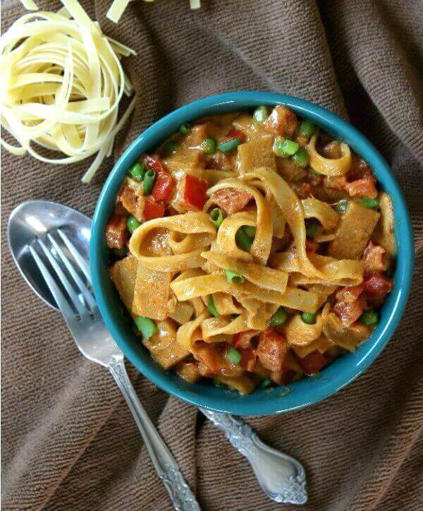 Curry pasta in a overhead photo with a fork and spoon on the side.