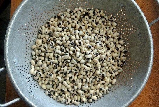 Slow Cooker Black Eyed Peas plumed and ready in an antique colander.