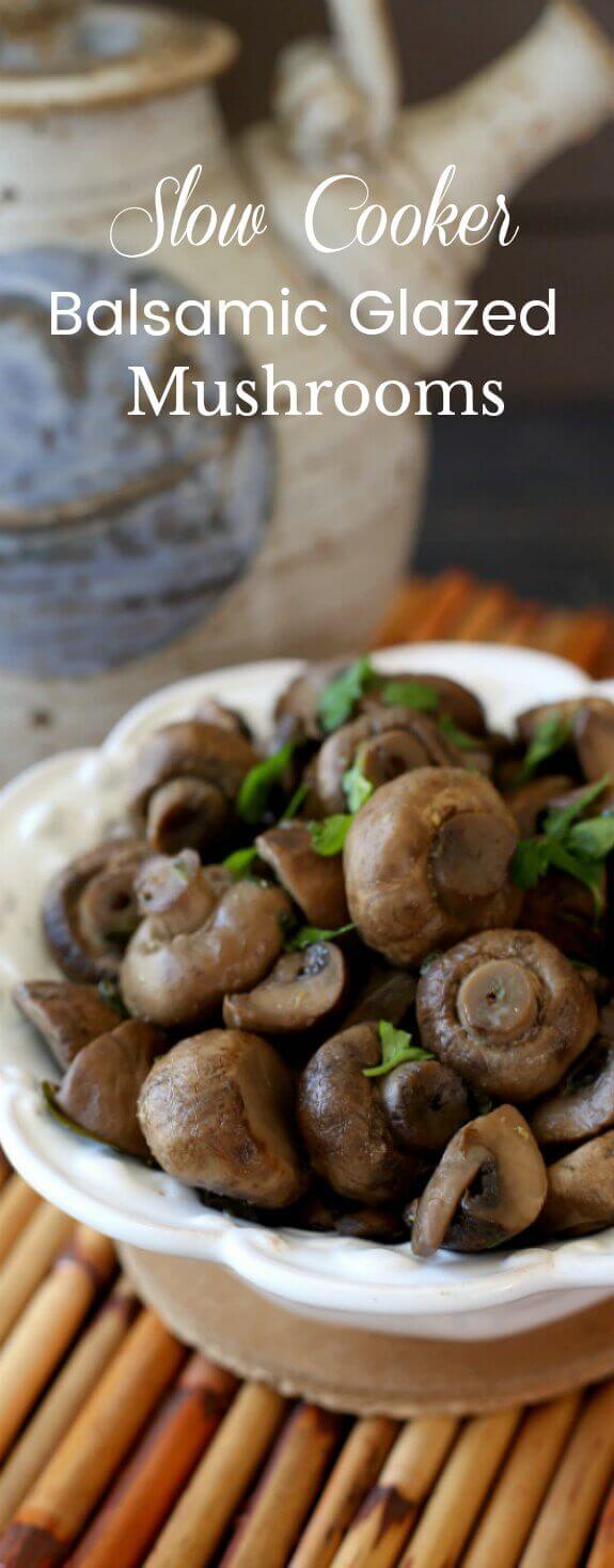 Slow Cooker Balsamic Glazed Mushrooms has the bowl full of cooked mushrooms cut in half so that there is an extreme close-up of the mushrooms that is sprinkled with fresh green parsley.