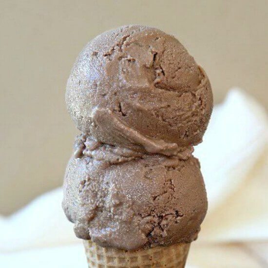 Two scoops of a frozen treat on a cone.