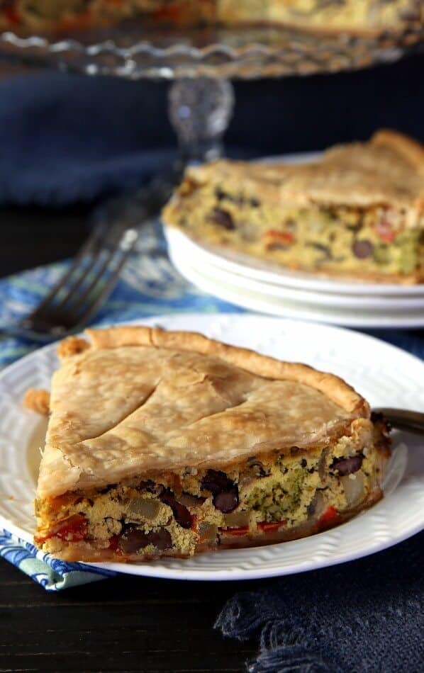 Slice of tofu pie sitting infront of complete pie with a slice missing.