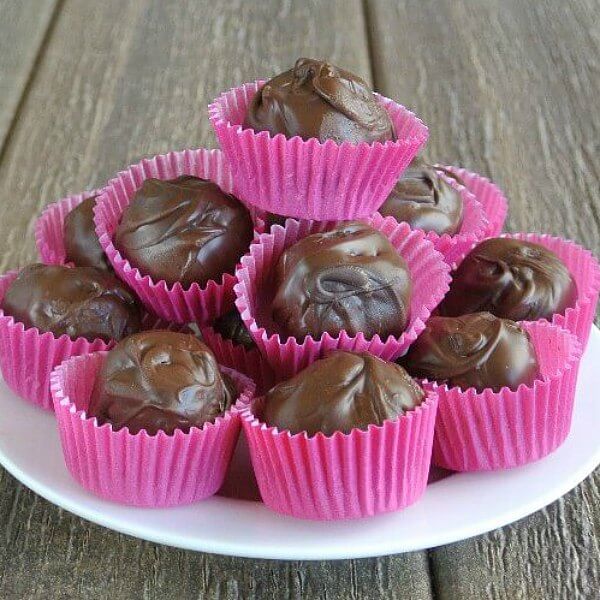 Chocolate candy stacked high on a plate.