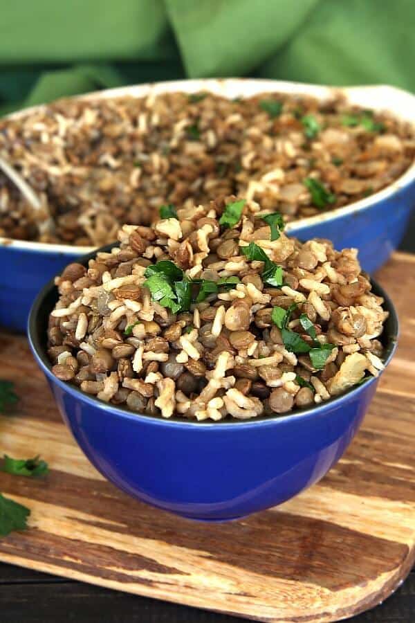 Classic rice, lentils, onion and spices mounded in a cobalt blue bowl and tilted forward.