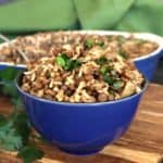 Classic rice, lentils, onion and spices mounded in a cobalt blue bowl and sprinkled with parsley.