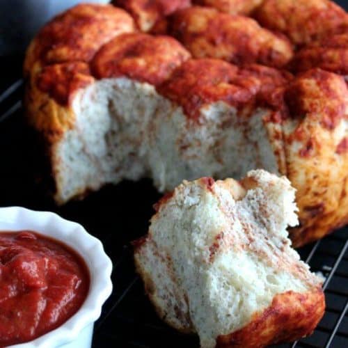 Slow Cooker Pizza Pull Apart Bread will call your name and beg you to pull off a big fat roll slathered in pizza sauce.   Take a bite, dunk it again and you just can't lose.