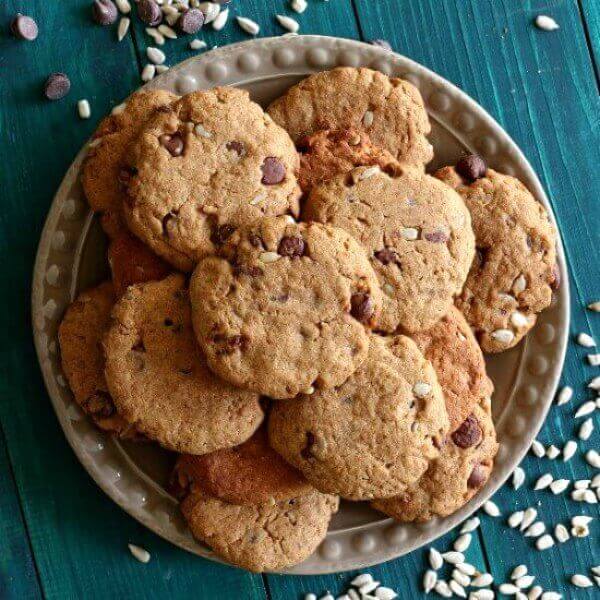 Sunflower Seed Chocolate Cookies are piled on a plate. Photo is from above looking down.