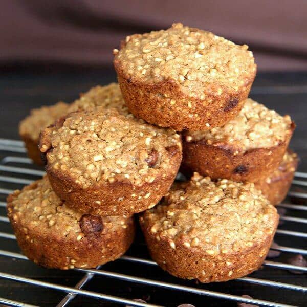Irish Oatmeal Chocolate Chip Muffins stacked in a casual pyramid with golden color and on the cooling rack.