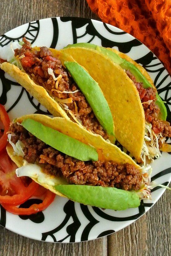 Mexican Sloppy Joe Tacos are three to a black and white plate.