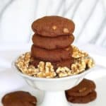 Chocolate Cake Cookies are stacked four high in a white footed compote.
