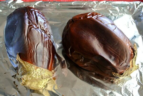 Baba Ganoush Dip is made from eggplant and here is a photo of two eggplants laying on foil after they have been roasted.