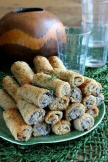 A pyramid pile of rolled and toasted mushroom rolls.