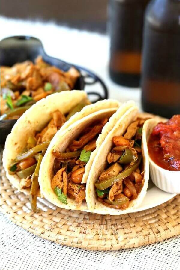 Vegan Fajitas with Meatless Chicken have tortillas lined up and piled high.