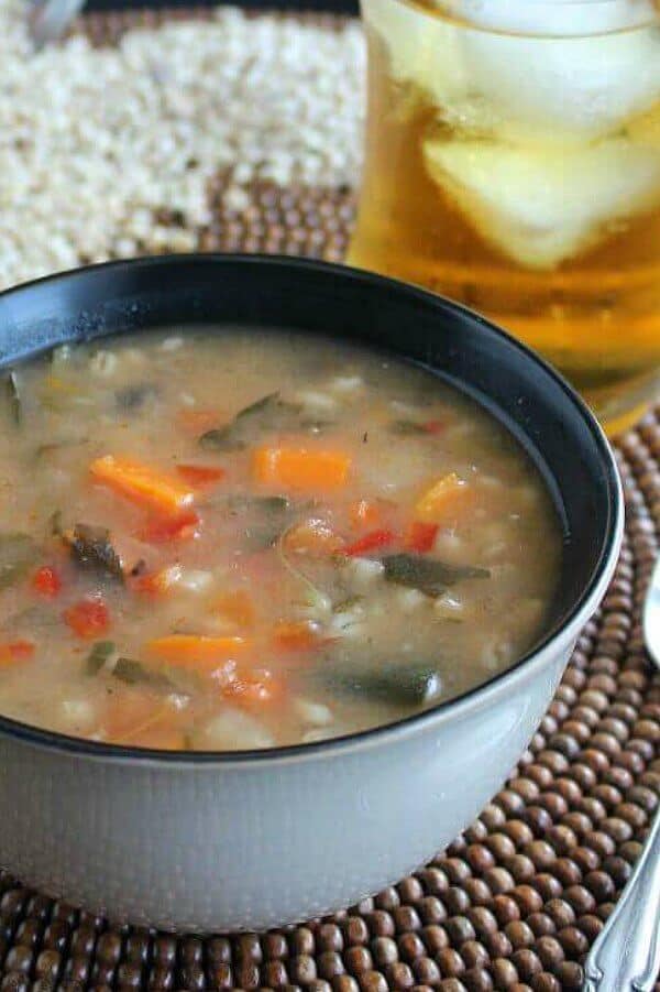 Vegetable Barley Soup in a side view of the rich brothy soup showing vegetables.