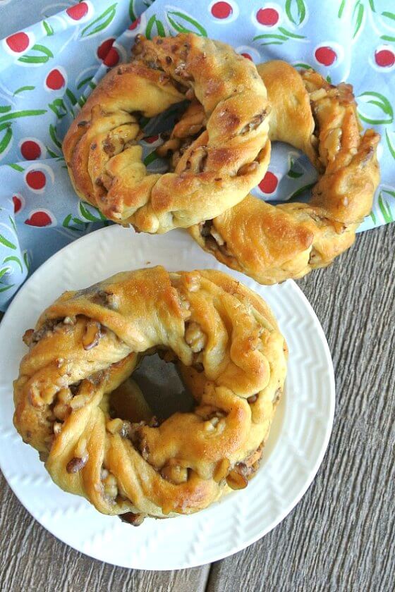 Crescent Roll Breakfast Rings are stacked and you are looking from above. Two more are scattered on the side.