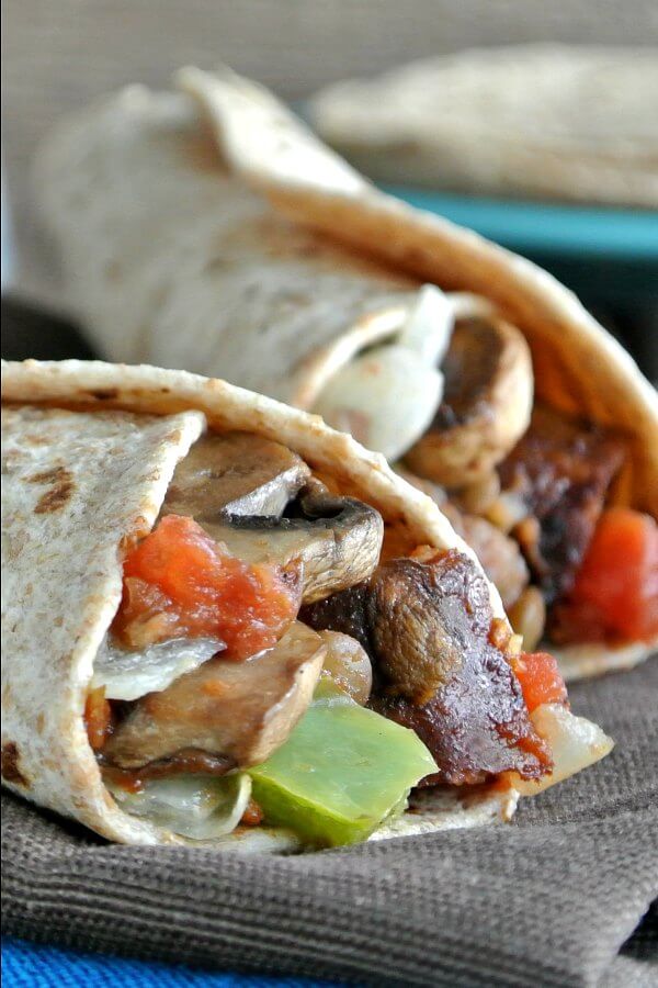 Two ends of burritos showing overflowing ingredients for a satisfying Mexican style breakfast.