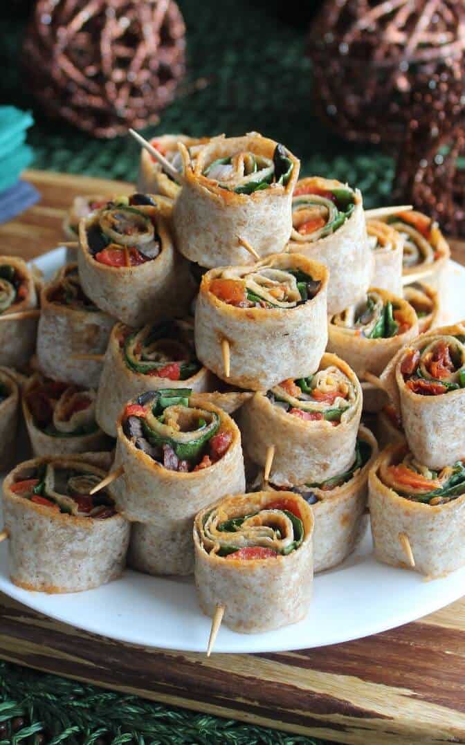 Spicy Tortilla Rollups are stacked as a pyramid and are included in the list of 17 Vegan Party Appetizers.