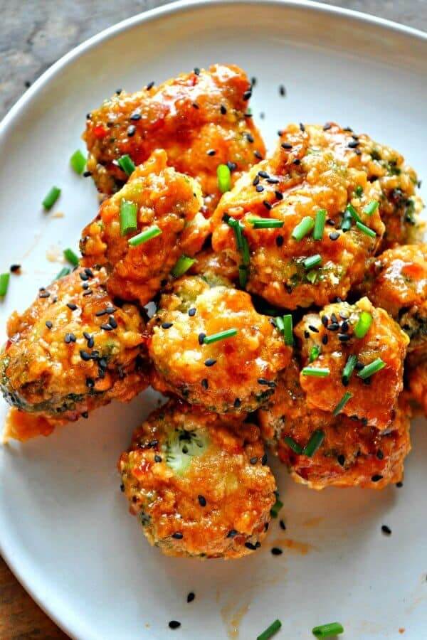 Overhead view of baked broccoli in a flavorful red sauce.