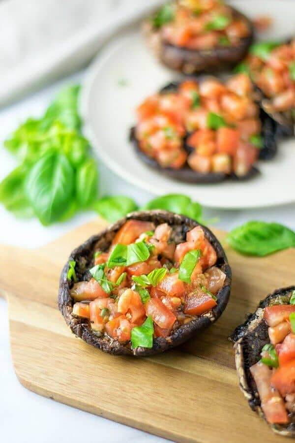 Portobello Mushroom Bruschetta has one portobello mushroom on it's back and is filled with the incredible filling that is included in 17 Vegan Party Appetizers.