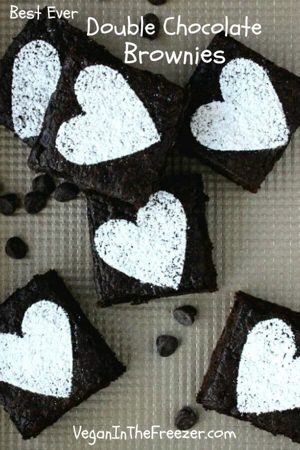 Best Ever Double Chocolate Brownies are an overhead view of brownie squares with sugar hearts on top.