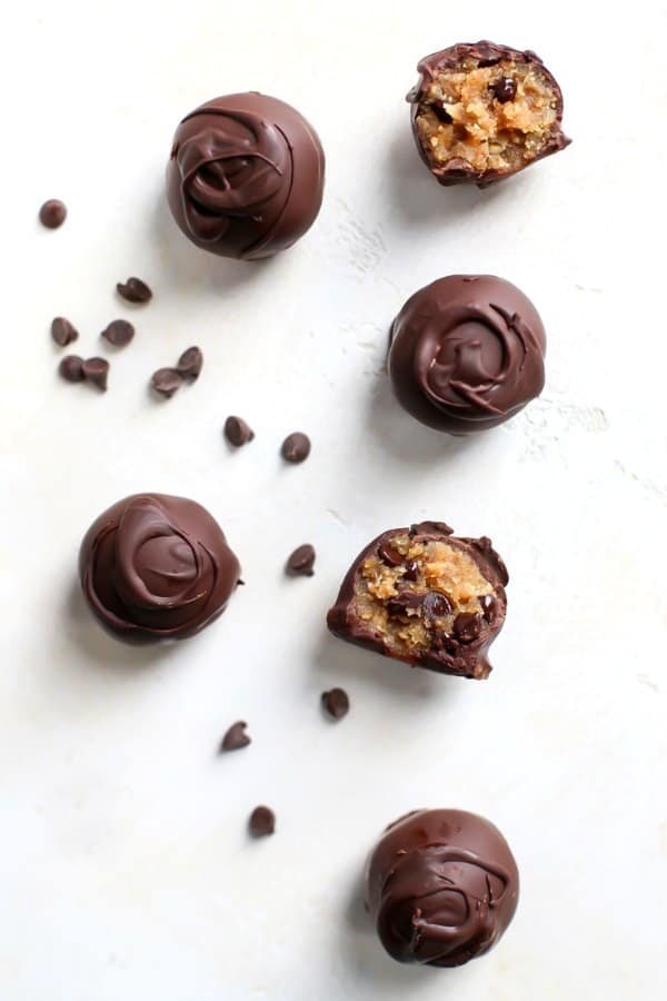 Chocolate Covered Cookie Dough on a white board and mini chocolate chips.