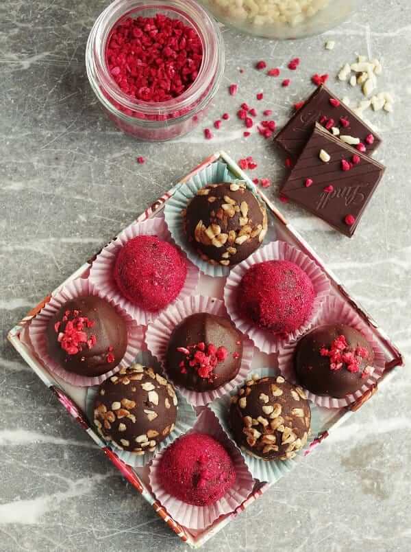 Valentine's Day Chocolate Truffles are boxed and showing gorgeous dusting of nuts, and berry powders or pieces.