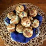 Silver metal basket is draped in cobalt with the best mini blueberry muffins piled high.